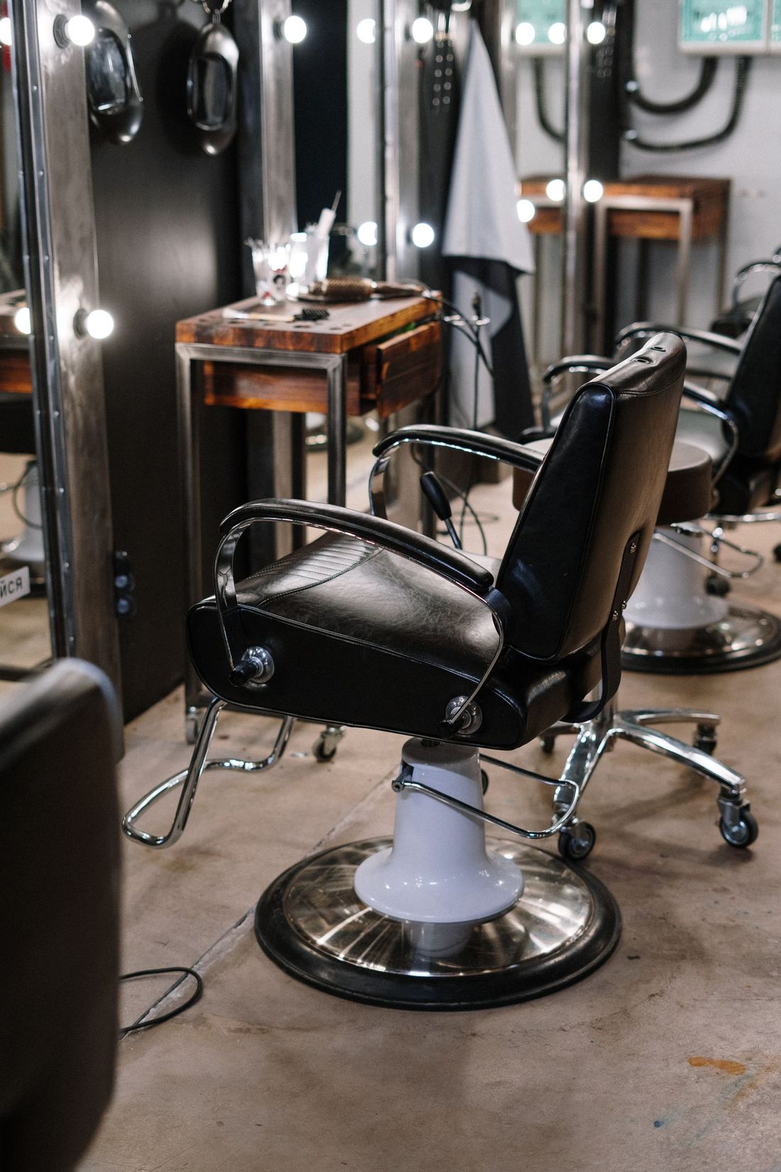 Row of classic barber chairs in front of mirrors